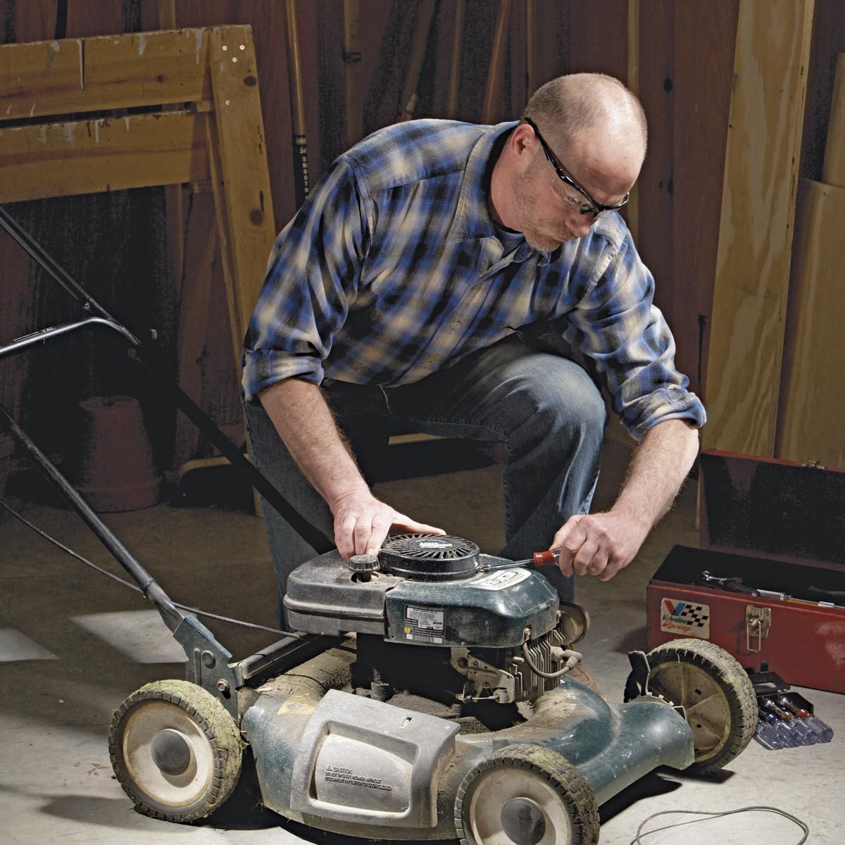 Man fixing lawnmower