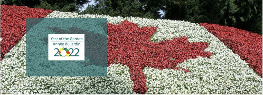 Mosaiculture garden showing Canada's flag in flowers with a mention of Year of the Garden 2022.