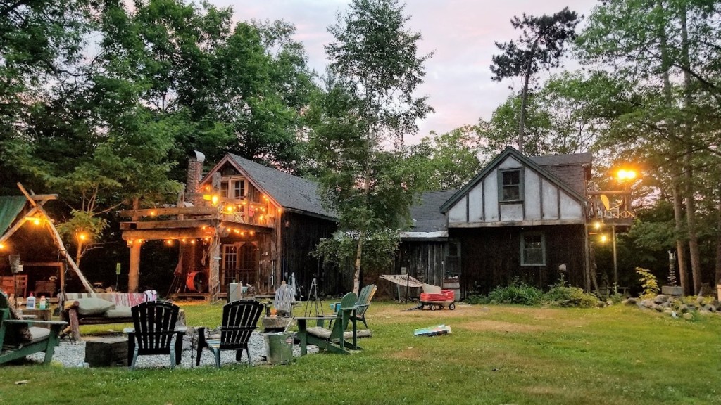 Large backyard with ampler rest area and Adirondack chairs.